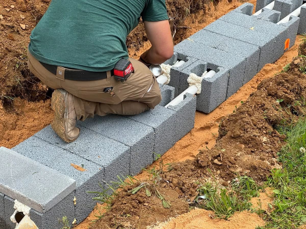 Concrete block foundation and septic tank enclosure being built