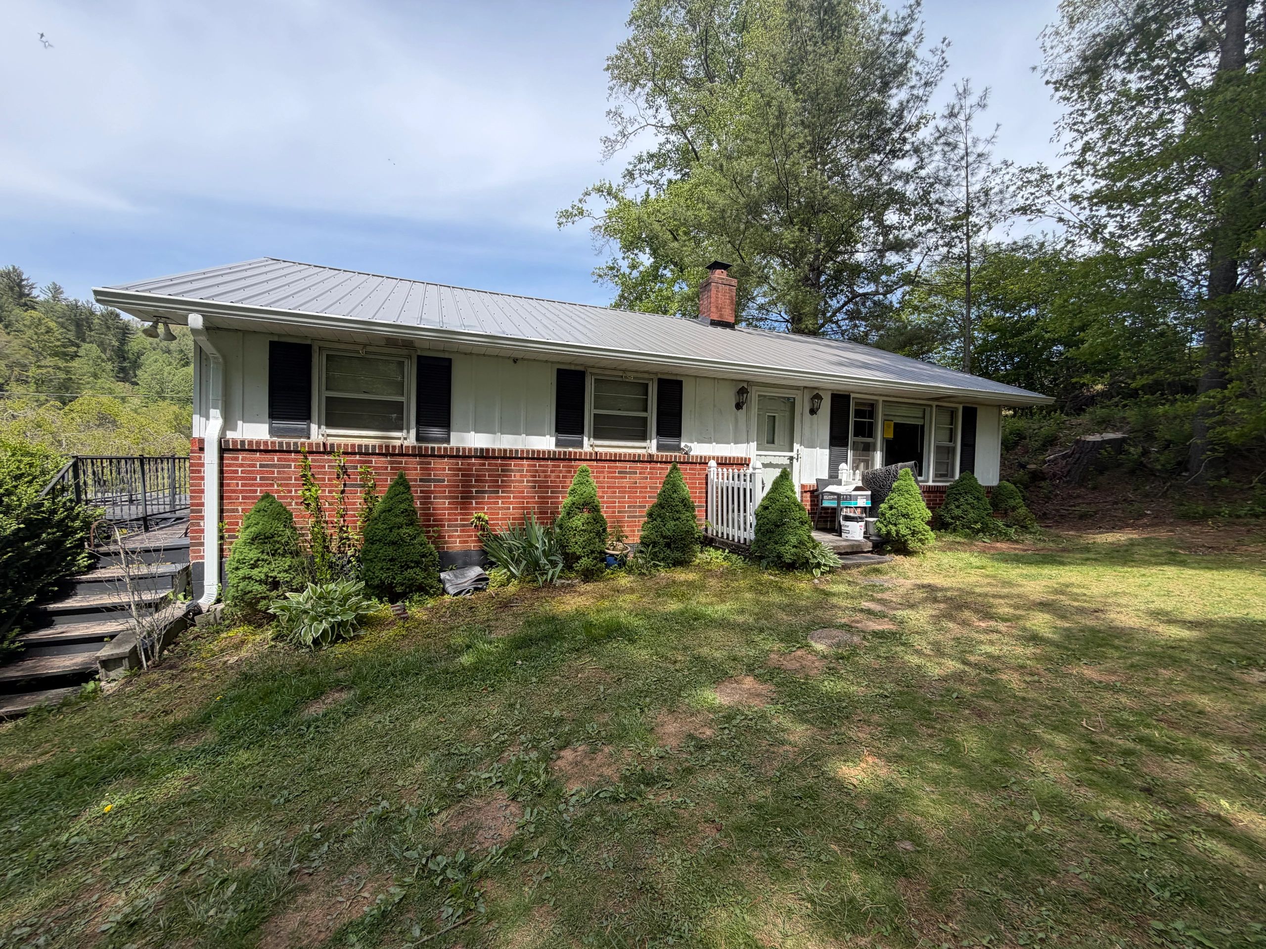 Ranch house exterior with metal roof and brick veneer