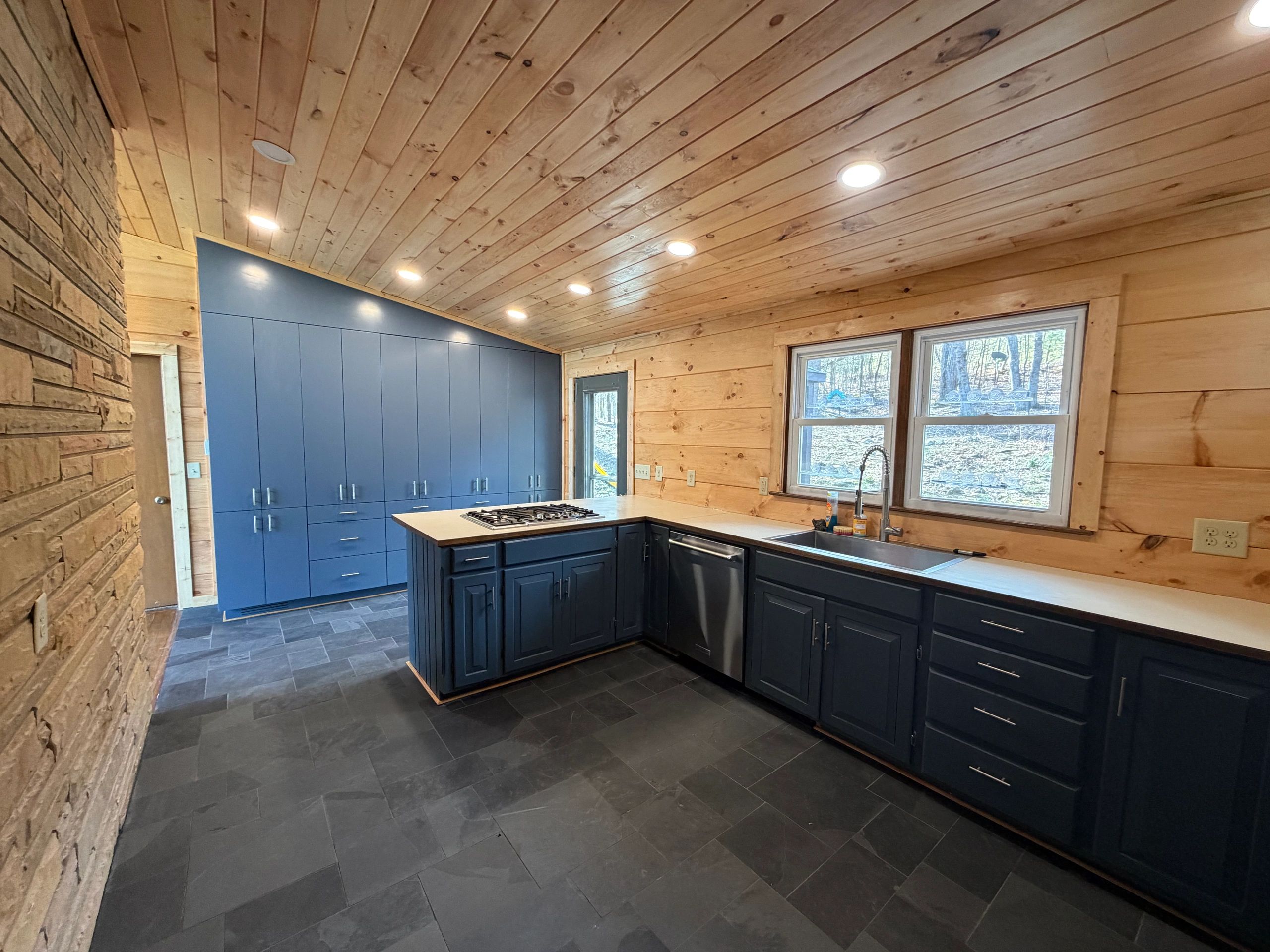 Modern kitchen remodel showing built-in cabinetry wall