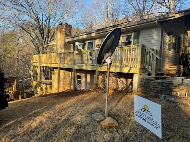 Deck and house exterior with Riverfront Group LLC yard sign visible